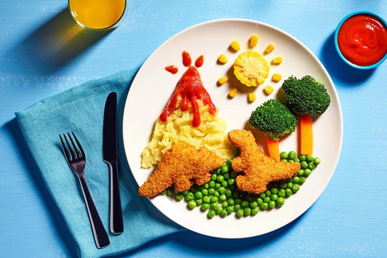 Quorn Roarsome vegan nuggets are displayed to show a scene including vegetables as trees and mash potatoes are a volcano.