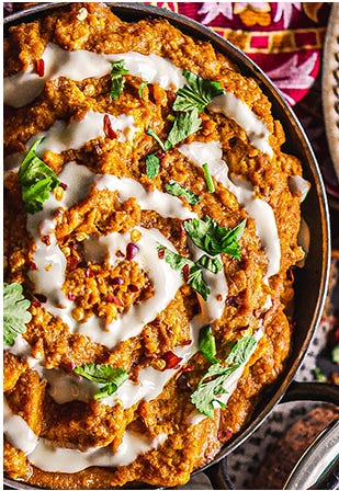 A vegan butter chicken curry made with Quorn Vegan Pieces topped with a swirl of vegan yogurt.