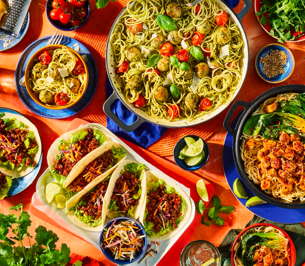 Colorful array of Quorn food dishes including pasta, tacos and stir-fries